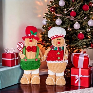 Christmas gingerbread gnome plush dolls with chef hat and candy in festive setting