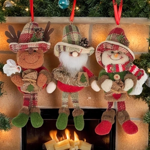 Detailed view of plush reindeer, Santa, and snowman hanging ornaments in a festive setting