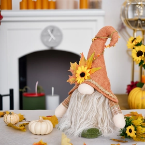 Detailed view of fall gnome decoration with sunflower and maple leaf on tweed hat