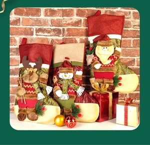 Detailed view of 3D Santa, Snowman, and Reindeer Christmas stockings on a brick wall