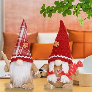 Detail of Christmas gingerbread gnome couple with rolling pin and candy buttons