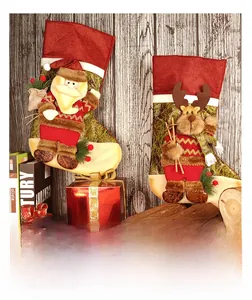 Detail of Christmas stockings with Santa and Reindeer characters on a rustic wood background