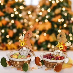Detail of harvest gnomes with sunflower hats and woven fruit baskets for fall decor