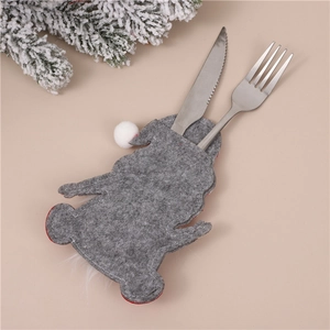 Detail of grey felt gnome cutlery holder with white pompom holding a steel knife and fork