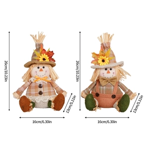 Pair of Thanksgiving harvest scarecrow dolls with sunflowers and maple leaves decoration
