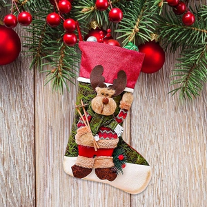 Christmas stocking gift bag featuring 3D skiing reindeer and festive green pine decorations
