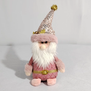 Détail de gnome de Noël en peluche rose avec bonnet à paillettes et barbe blanche