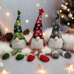 Close-up of three Christmas gnomes with knit hats and long beards on white fur