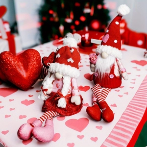 Detail of Valentine's Day gnomes with striped legs and knit heart hats for decor