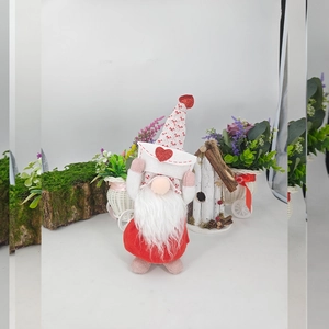 Detail of Valentines gnome plush with red sequin hearts and knitted pattern hat