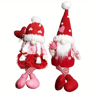 Close-up of Valentine's gnomes with red knit hats, white braids, and sequined hearts