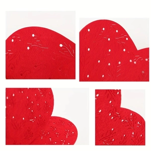 Macro detail of laser-cut red heart placemat with floral hollow pattern for dining decor