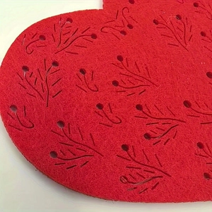 Red heart-shaped felt placemat with hollow-out berry pattern for Valentine table decor