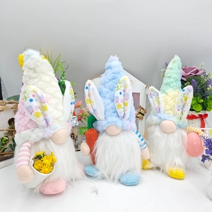 Detail of Easter gnomes plush set with bunny ears holding carrots and colorful eggs