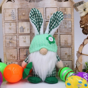Detail of Easter gnome plush with bunny ears holding a carrot against wooden calendar
