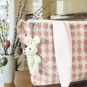 Detail of pink houndstooth Easter basket bag with plush bunny ears and soft charm