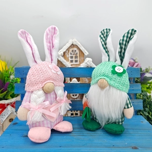 Macro view of Easter gnome pair with bunny ears and plaid fabric on a blue bench