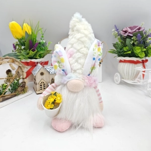 Easter gnome plush detail with rabbit ears and bucket of flowers on spring backdrop