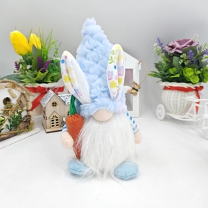 Detailed view of an Easter gnome plush with bunny ears holding a bright felt carrot