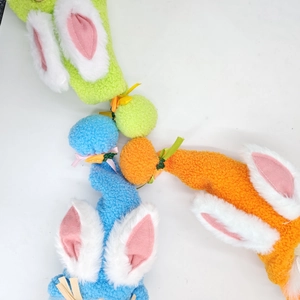 Close-up of Easter gnomes featuring long rabbit ears and soft carrot plush texture