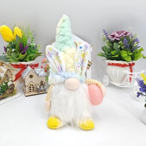 Close-up of Easter gnome plush with floral bunny ears holding a pink polka dot egg decor