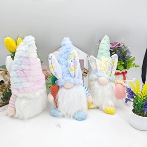 Detailed view of three Easter gnomes with rabbit ears, carrot and egg in pastel colors