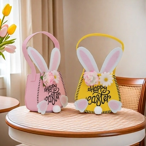 Felt Easter gift bags with Happy Easter text and bunny tail on wooden table