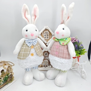 Close-up of Easter rabbit plush dolls with telescopic legs and plaid outfits decor