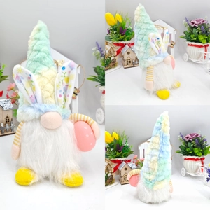 Front, side, and back views of a plush Easter gnome with bunny ears and a pink egg