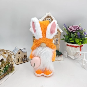 Detail of Easter gnome plush with bunny ears holding a pink egg with Love lettering