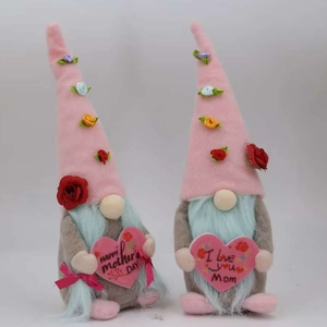 Detail of two Mother's Day gnomes with pink floral hats holding soft plush hearts