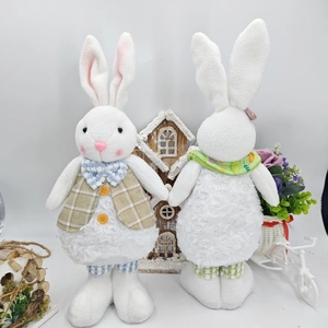 Close-up of Easter plush bunnies in plaid vests and floral scarves with soft lamb wool texture