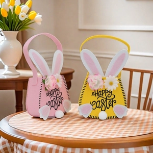 Detail of pink and yellow felt Easter bags with bunny ears and Happy Easter print