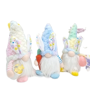 Three Easter gnomes set with bunny ears holding carrot, basket and egg on white background