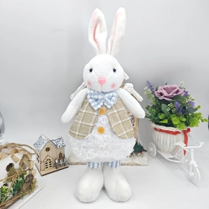 Detail of Easter bunny doll in plaid vest with lamb wool texture and garden decor