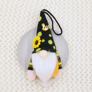 Detail of bee gnome ornament with sunflower accents and knitted hat on heart tray