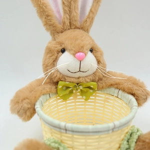 Detail of plush brown bunny basket with woven texture and green polka dot bow tie decoration