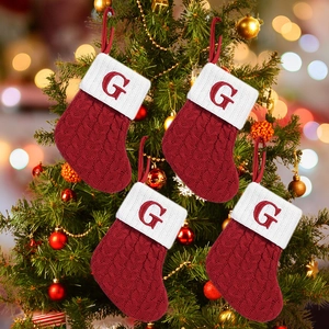 Classic red cable knit Christmas stocking with white cuff and red embroidered letter G