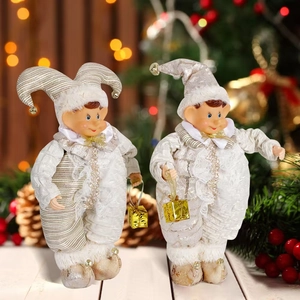 Close-up of silver Christmas elf dolls with shiny sequins, fur trim and festive bells