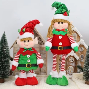 Christmas gnome plush dolls with sequin hats and bells on white fur background
