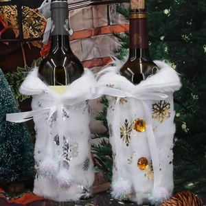 Plush Christmas wine bottle covers with silver and gold snowflake patterns and pom-poms
