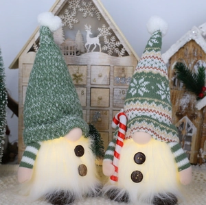 Lighted Christmas gnomes with knit hats and warm LED glowing beards on plush carpet