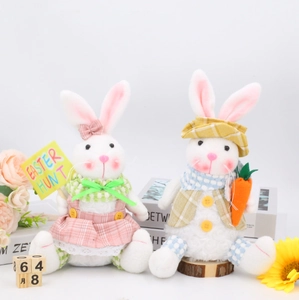 Detail of plush Easter bunnies with Easter Hunt sign and carrot decorations