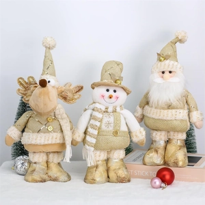 Detail of Christmas reindeer, snowman and Santa dolls with gold sequins and white fabric