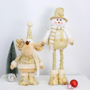 Detail of champagne gold reindeer and snowman plush dolls with glitter fabric on white fur