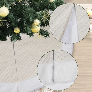 Detail of cream quilted Christmas tree skirt with plush white faux fur edge and velcro