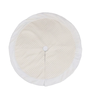 Detail of beige quilted Christmas tree skirt with white faux fur trim and radial opening
