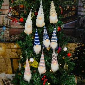 Detailed view of Christmas Swedish gnomes hanging on a tree with knitted patterns