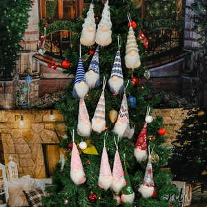 Detailed view of 15 handmade Christmas gnomes ornaments hanging on a festive pine tree