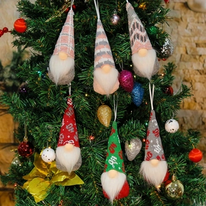 Detail of six handmade Christmas gnome plush ornaments with diverse patterns on a tree